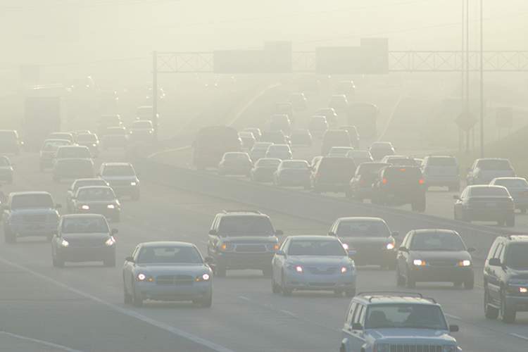 Smog and air pollution with cars on highway.