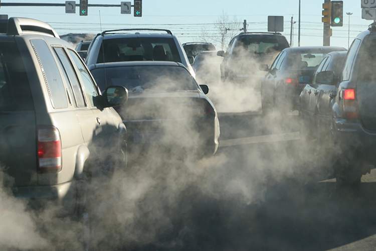 Cars and car exhaust on a busy street.