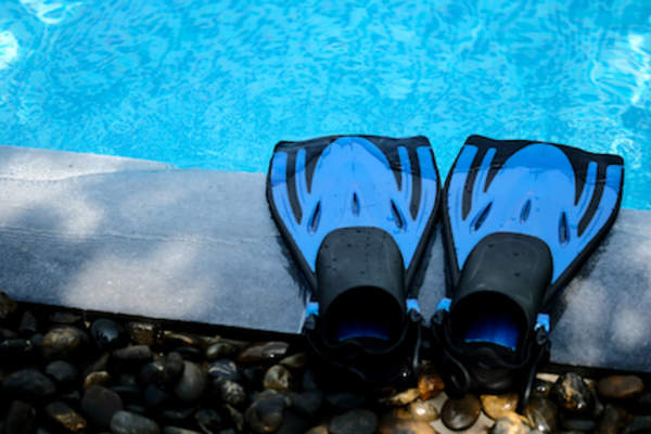 Swim fins by pool edge.