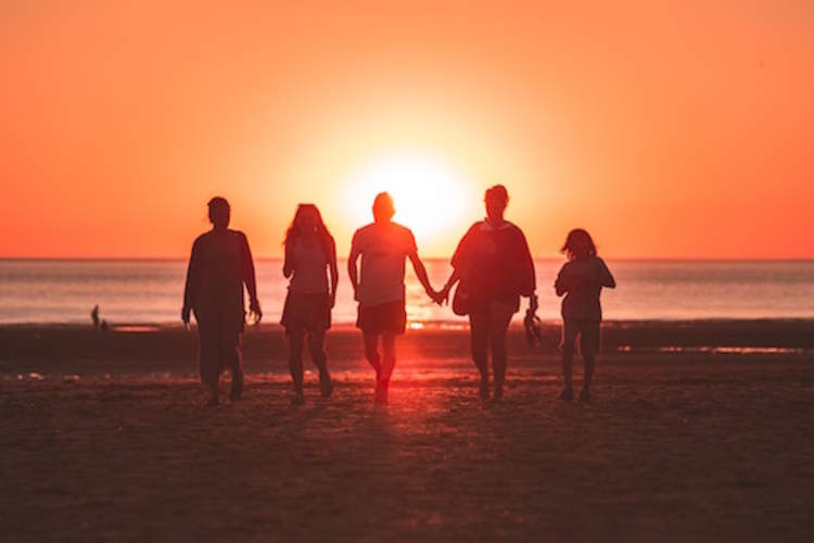 Family leaving beach