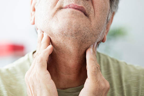 Senior man feeling pain in his throat.