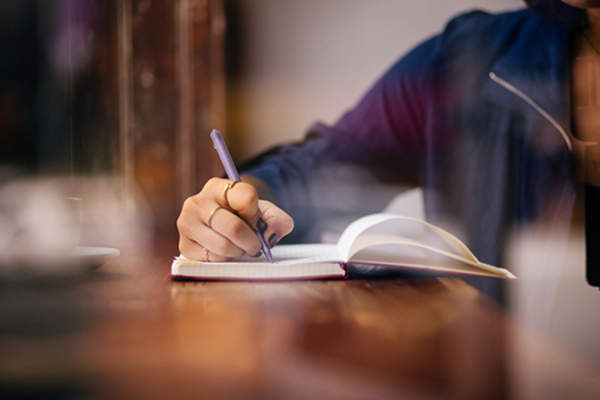 Woman making a list image.