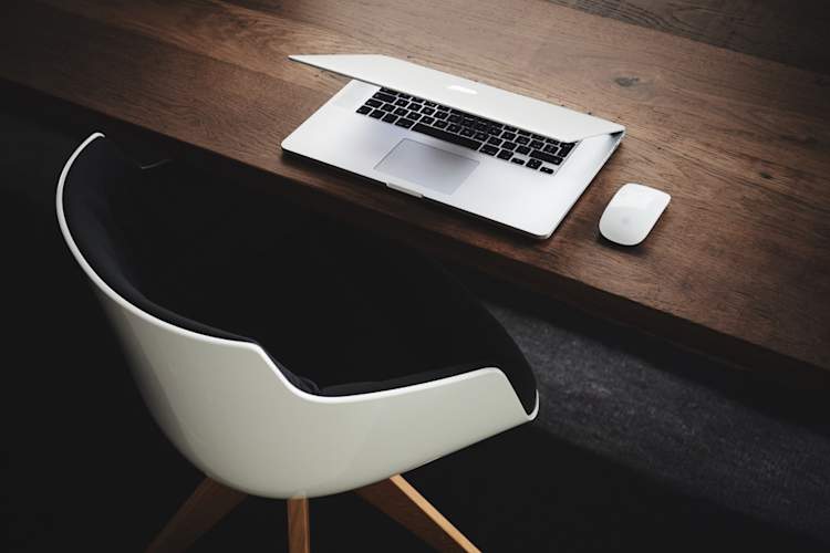laptop and desk chair in office
