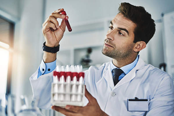 Doctor examining blood vials.