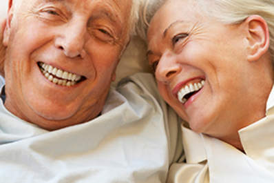 Senior Couple Relaxing In Bed