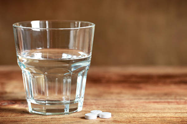 Tablets and a glass