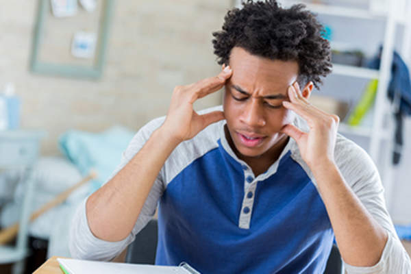 Teenage student is frustrated while doing homework.