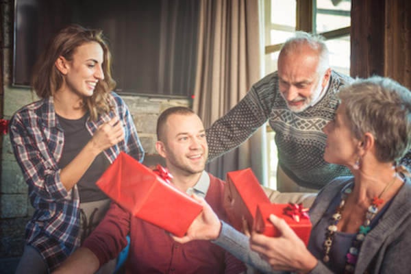 Family exchanging Christmas gifts.