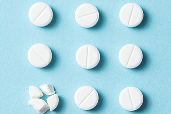White pills on a blue background.