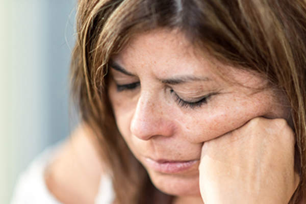 Sad woman experiencing menopausal mood swings.