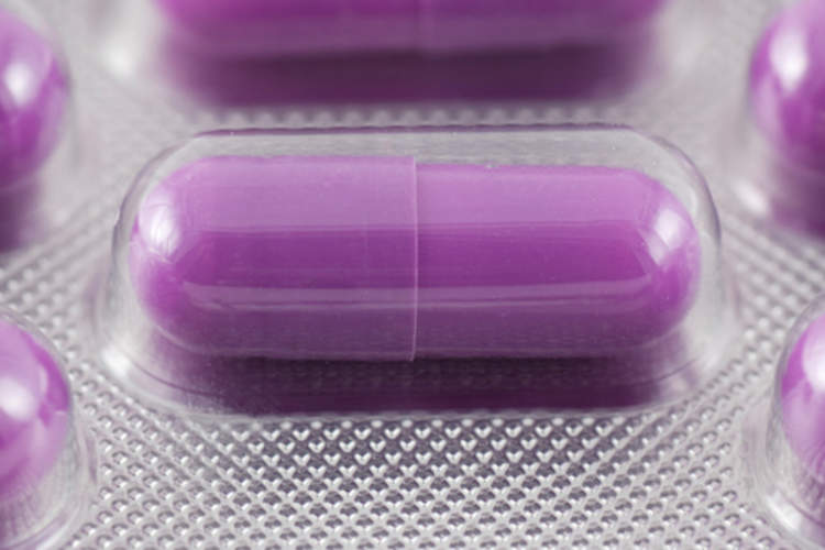 Purple acid-reducing pill in blister pack.