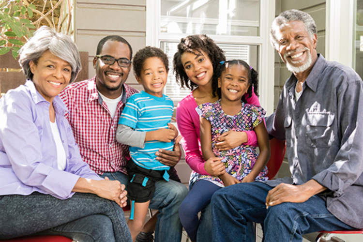 Smiling family in portrait on porch.
