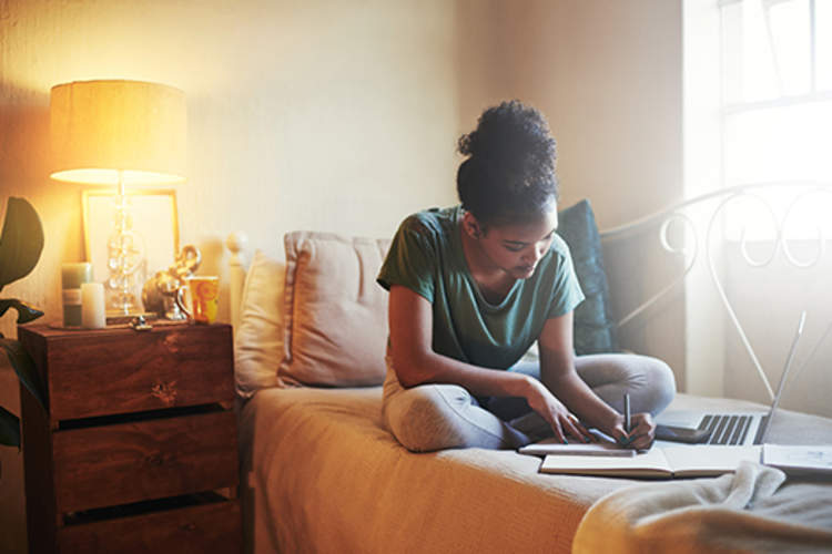 College student studying in her dorm room.