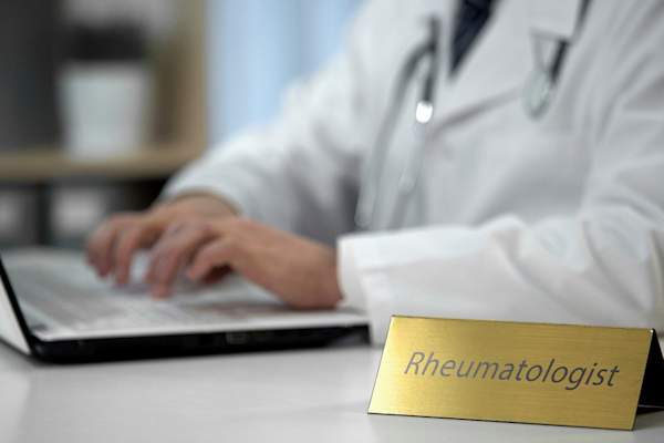 Rheumatologist on computer.