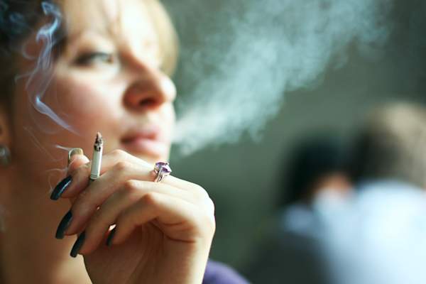 Woman smoking a cigarette.