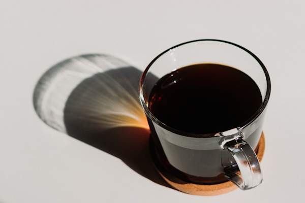 black coffee in clear cup