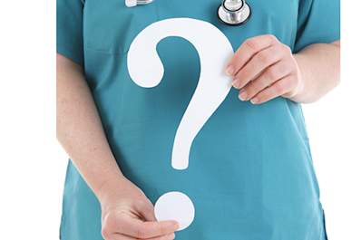 Doctor holding question mark.