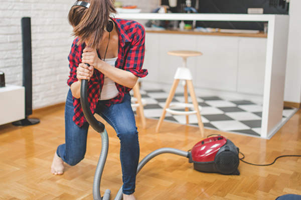 woman dancing while vacuuming image