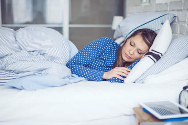 Woman sleeping peacefully in bed.