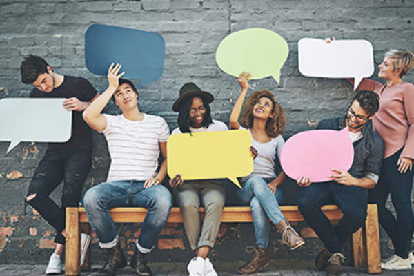 Group of people holding speech bubbles.
