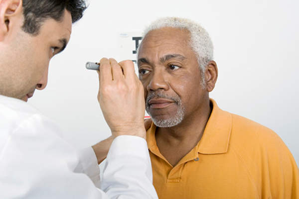 Senior man getting eye exam.