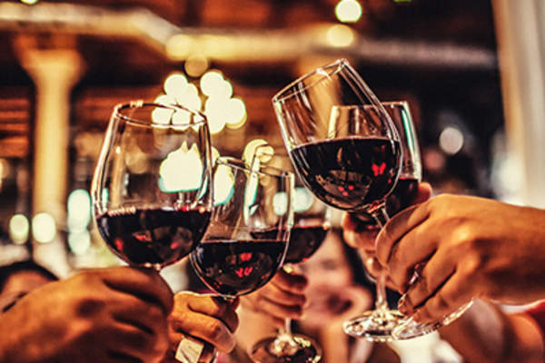 Friends drinking wine at night.