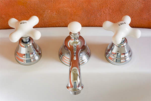 Hot and cold water spigots in sink.