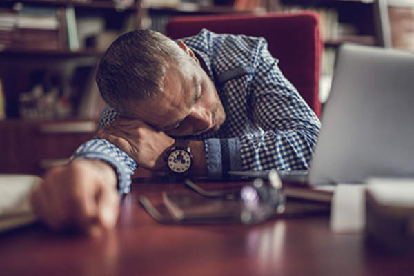Exhausted man at work.