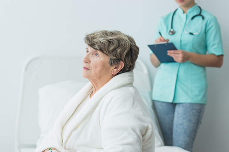 Nurse checking on Alzhemeir's patient