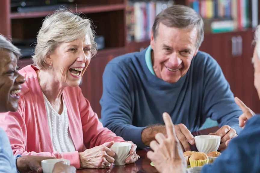 group of seniors talking over coffee
