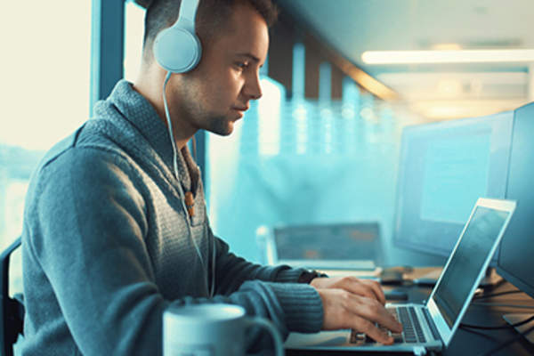 Man sitting at his desk at work with good posture.