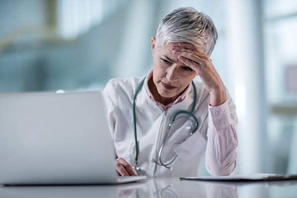 Doctor working out diagnosis.