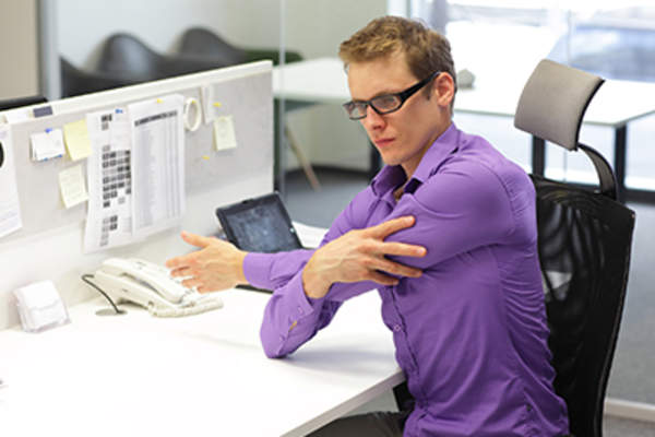 Man doing preventative exercises in the office.