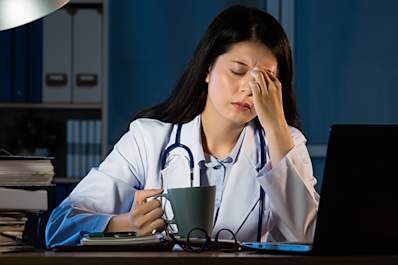 Tired doctor working at night.