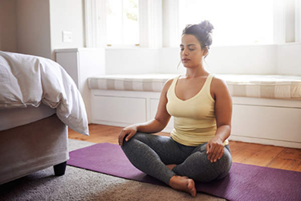 Woman meditating to relieve stress.