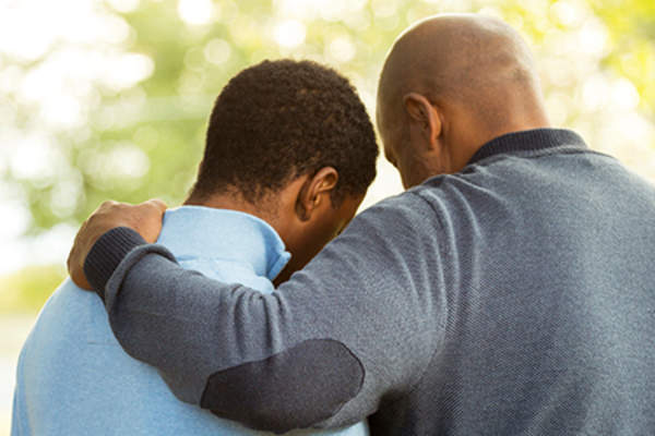 father and upset son image