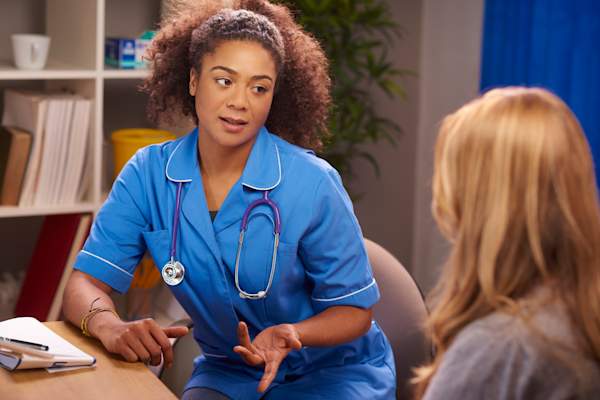 Female nurse chatting to patient