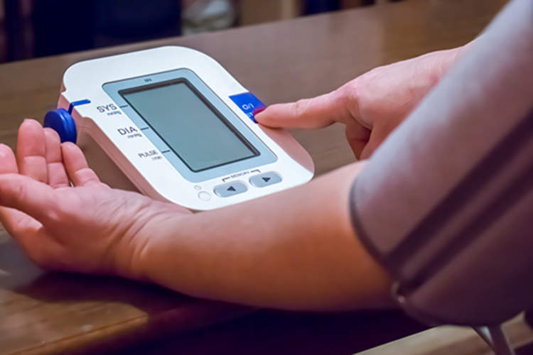 Woman checking her blood pressure.