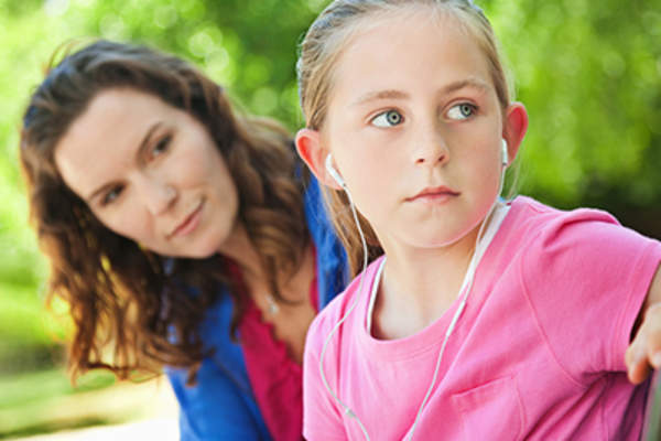 Young daughter turning away from her mother.