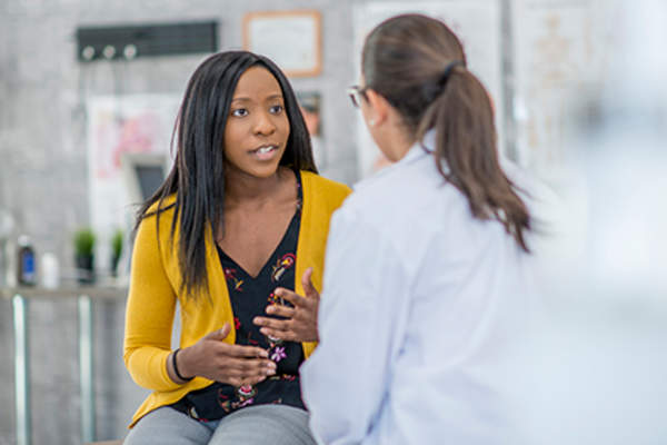 Patient explaining something to her doctor.