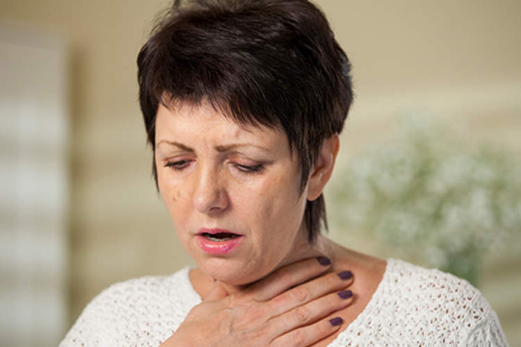 woman having trouble breathing image