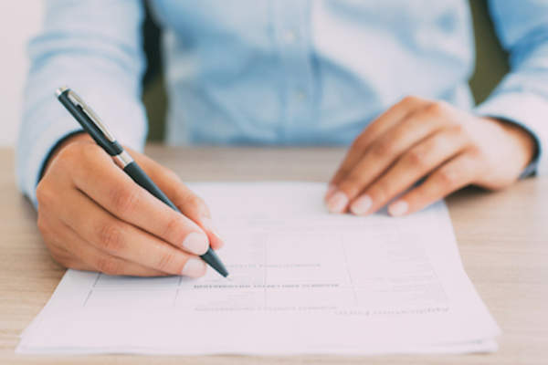 Person filling out questionnaire.