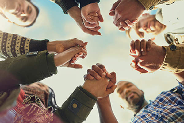 Friends holding hands and showing support.
