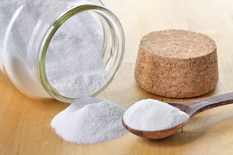 Baking soda in bottle and spoon.