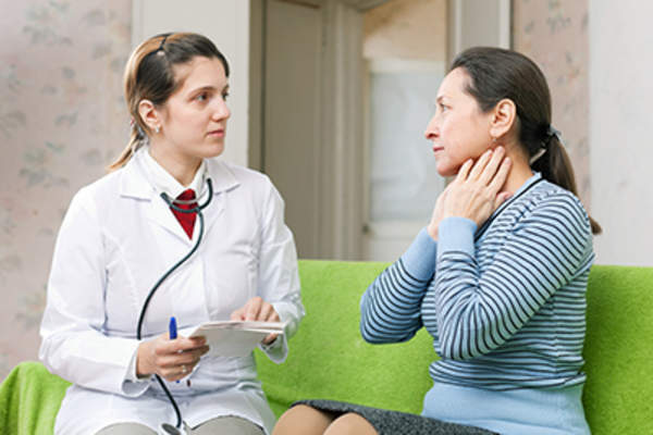 Serious doctor examining mature woman