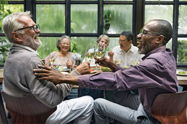 Mature adults having fun at a dinner party.