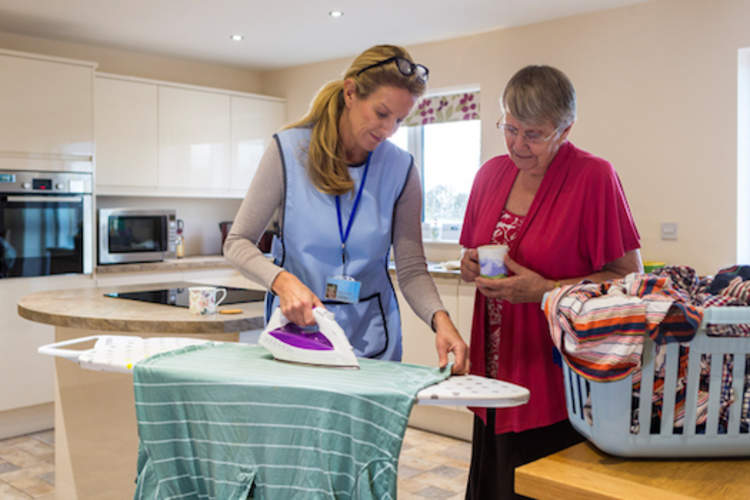 Housekeeper helping with the ironing.