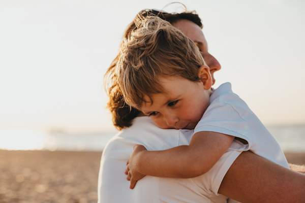 Young boy hugging his mother