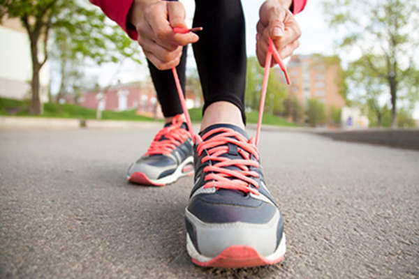Jogger tying shoelaces.