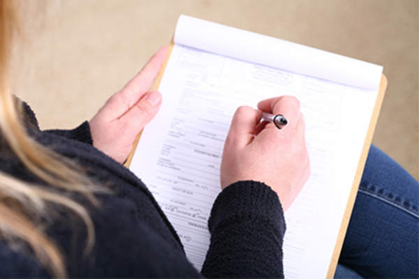 Woman filling out medical form.